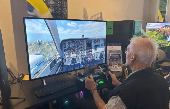 seniors using flight simulator at museum