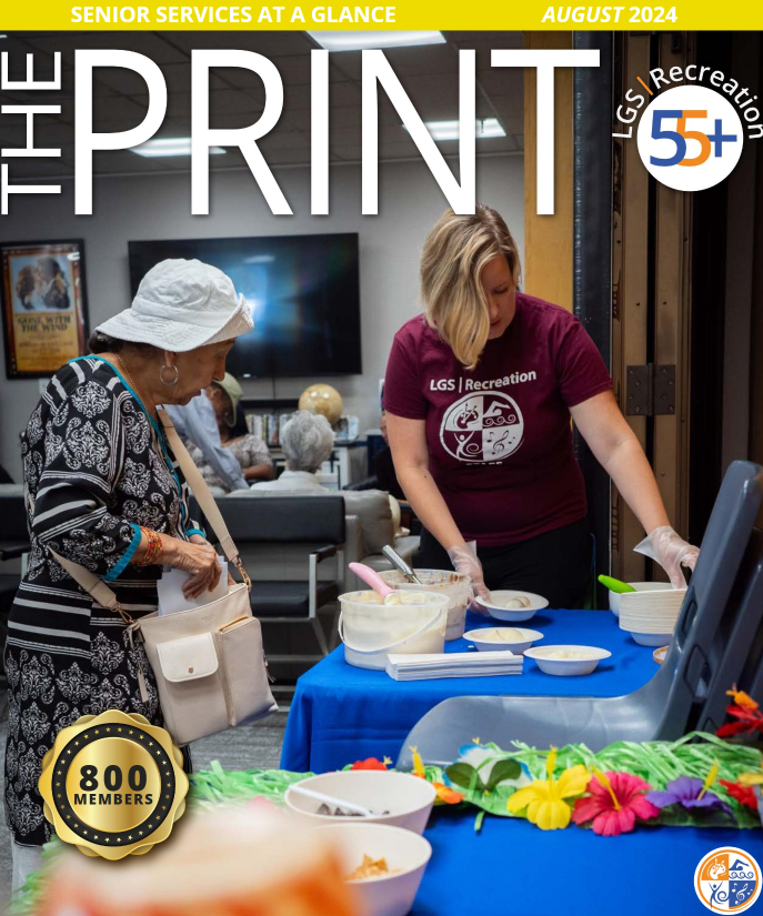 Staff helping senior scoop ice cream at 55+ event