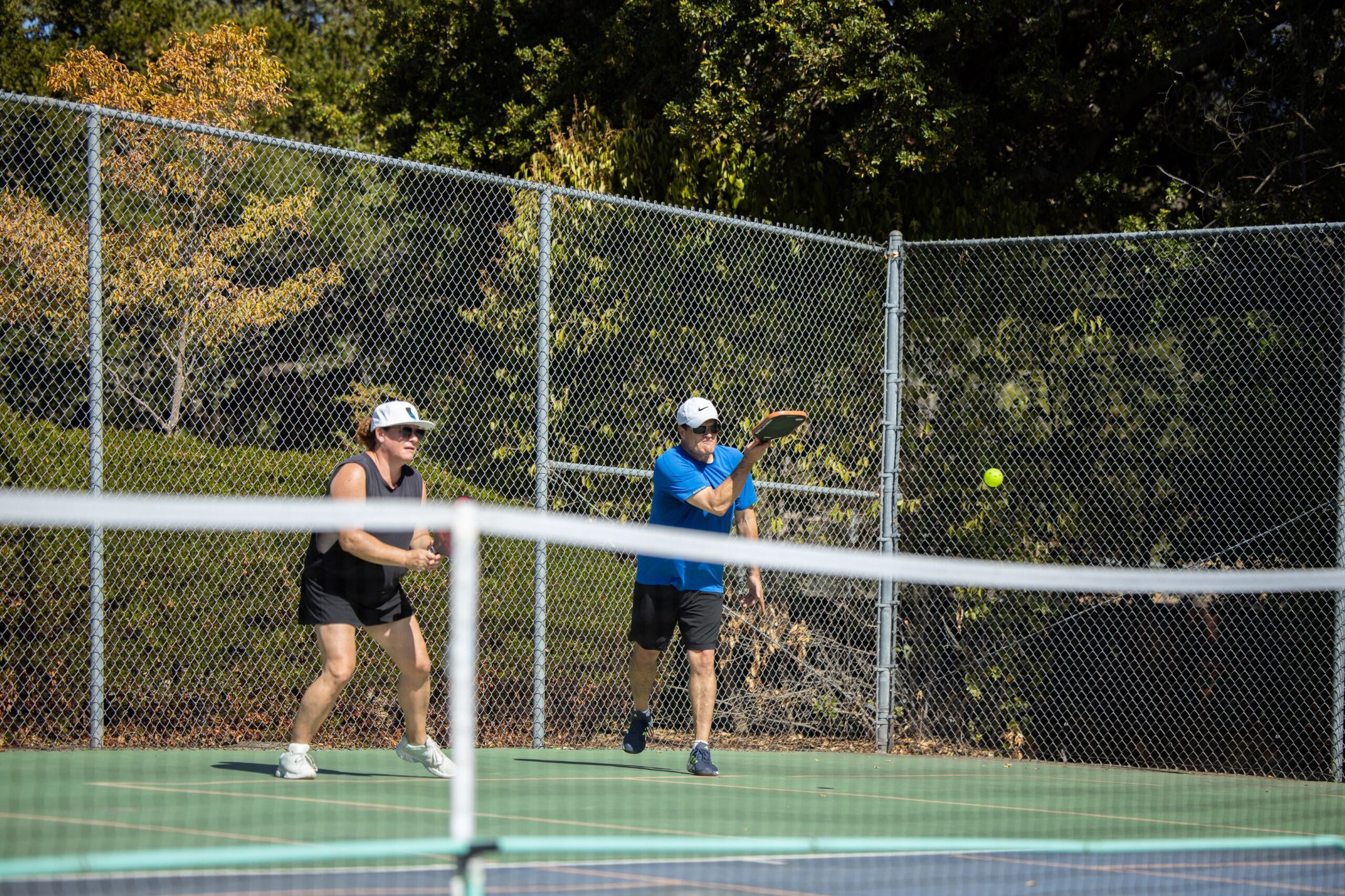 pickleball players hitting a ball