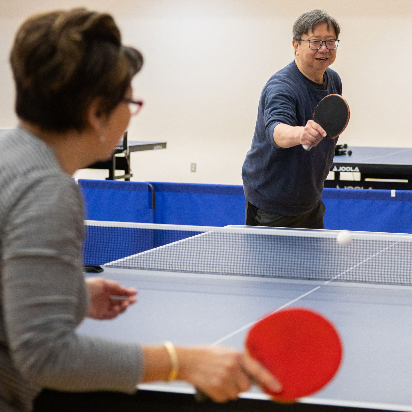 Adults playing table tennis
