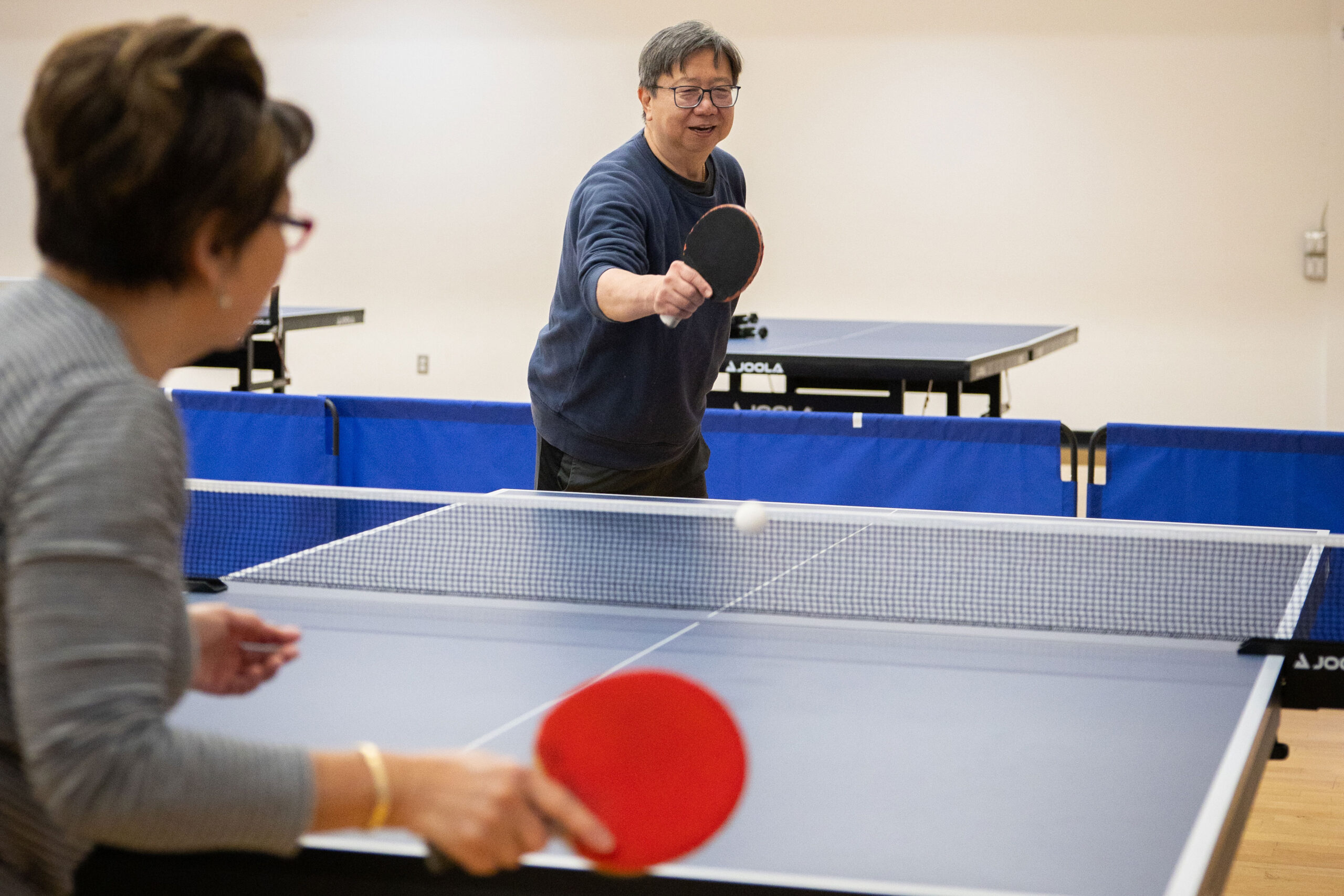 Adults playing table tennis