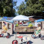 preschoolers outside on some tricycles
